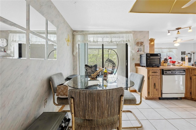 dining space with a ceiling fan, a toaster, and light tile patterned flooring