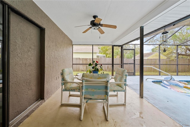 sunroom / solarium with ceiling fan, plenty of natural light, and outdoor dining area