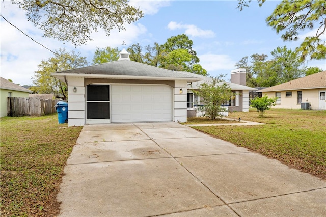 ranch-style house featuring central AC unit, driveway, fence, and a front lawn