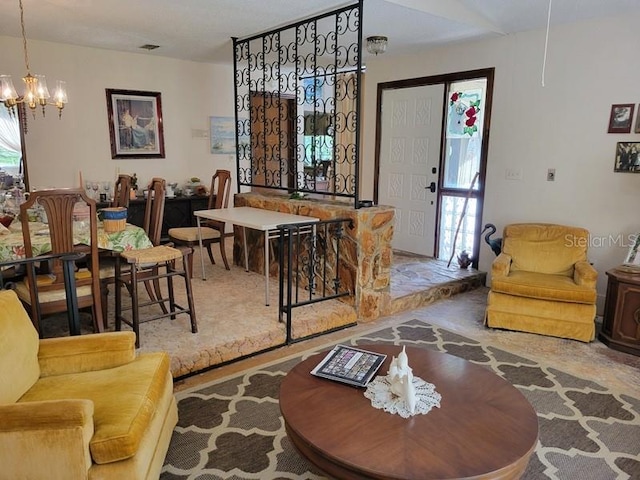 living room featuring an inviting chandelier and visible vents