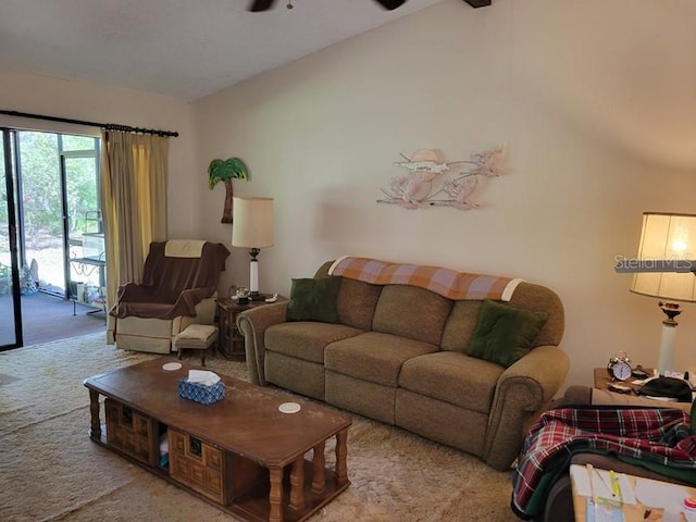 living area featuring a ceiling fan, lofted ceiling, and carpet