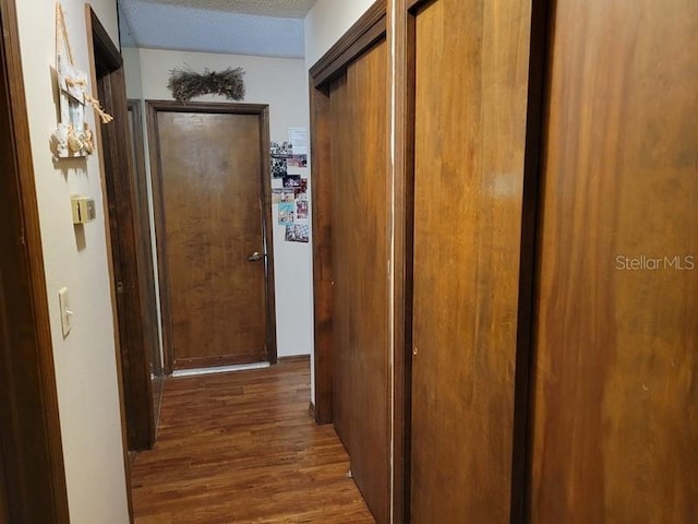 corridor featuring wood finished floors