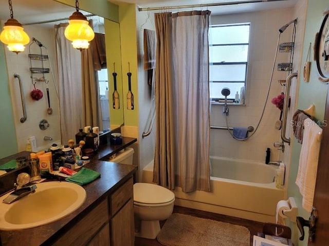 bathroom featuring toilet, vanity, and shower / bath combo with shower curtain