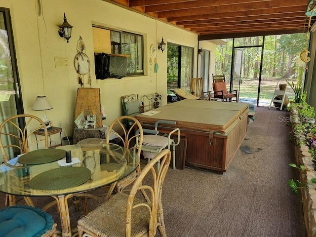 sunroom / solarium featuring carpet flooring and a jacuzzi