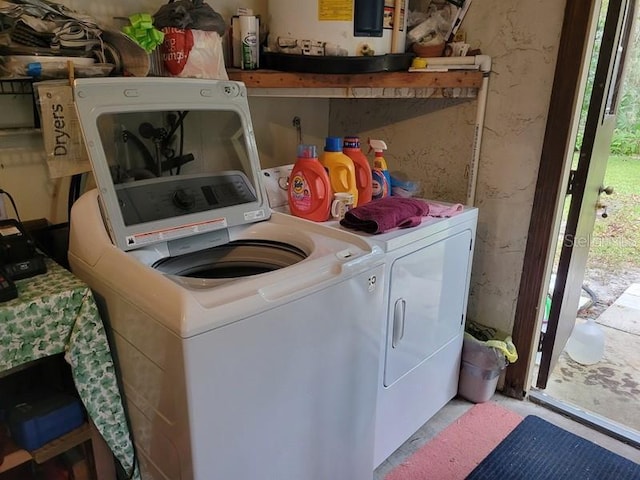 laundry room featuring independent washer and dryer and water heater