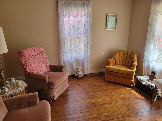 sitting room featuring baseboards and hardwood / wood-style floors