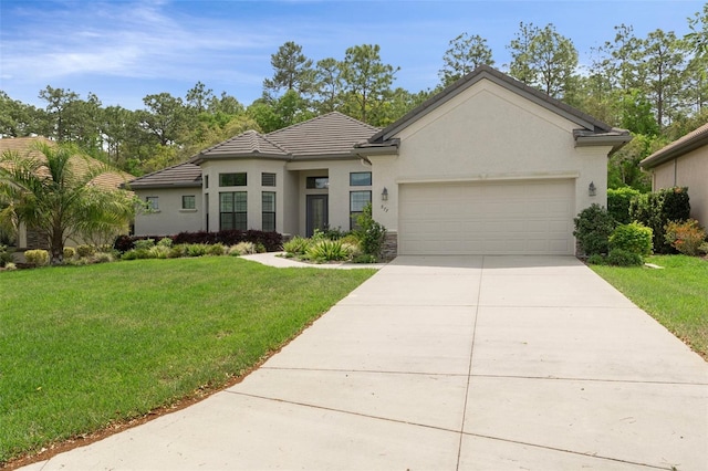 877 N Hunt Club Dr, Hernando, FL 34442 - view of front of home featuring an attached garage, concrete driveway, a tile roof, stucco siding, and a front lawn