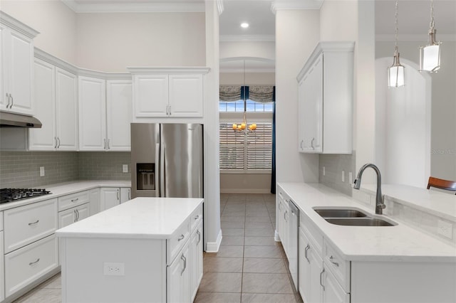 877 N Hunt Club Dr, Hernando, FL 34442 - kitchen with a sink, ornamental molding, under cabinet range hood, white cabinetry, and stainless steel appliances