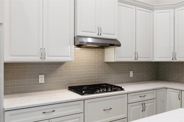877 N Hunt Club Dr, Hernando, FL 34442 - kitchen with under cabinet range hood, stainless steel gas cooktop, and white cabinetry