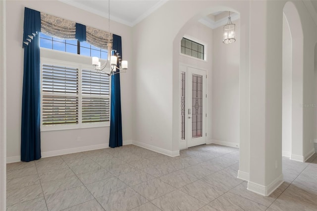 877 N Hunt Club Dr, Hernando, FL 34442 - interior space featuring crown molding, arched walkways, a towering ceiling, a notable chandelier, and baseboards