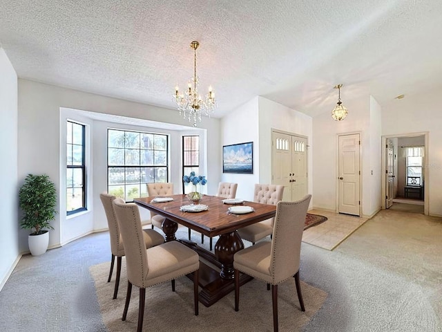 dining room featuring a chandelier, baseboards, a textured ceiling, and light colored carpet