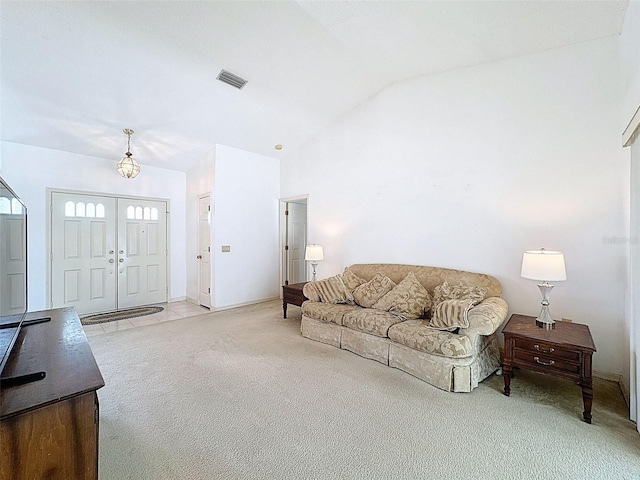 living area featuring lofted ceiling, visible vents, baseboards, and light carpet