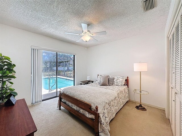 bedroom featuring light carpet, visible vents, access to outside, and a textured ceiling