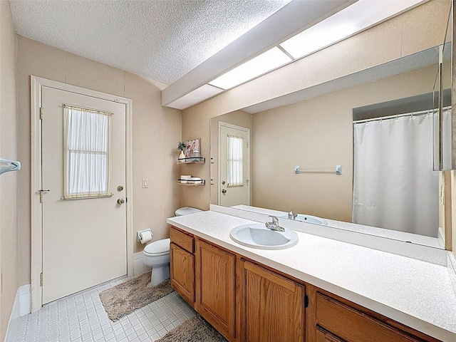 bathroom featuring tile patterned floors, a textured ceiling, vanity, a shower with curtain, and toilet