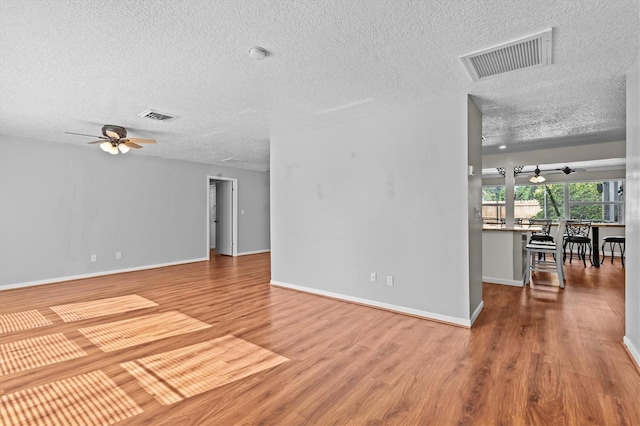 155 Patty Ann Blvd, Palm Harbor, FL 34683 - unfurnished living room featuring visible vents, a ceiling fan, and wood finished floors