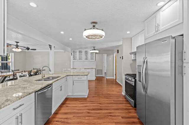 155 Patty Ann Blvd, Palm Harbor, FL 34683 - kitchen with a sink, white cabinetry, and stainless steel appliances
