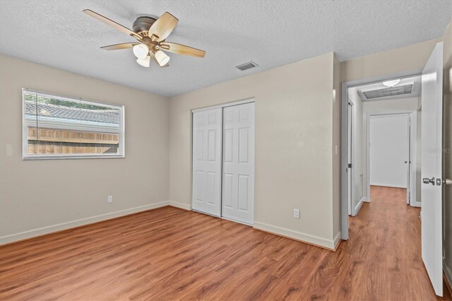 155 Patty Ann Blvd, Palm Harbor, FL 34683 - unfurnished bedroom featuring visible vents, baseboards, a closet, and light wood-style floors