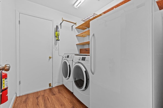 155 Patty Ann Blvd, Palm Harbor, FL 34683 - clothes washing area with laundry area, separate washer and dryer, and wood finished floors