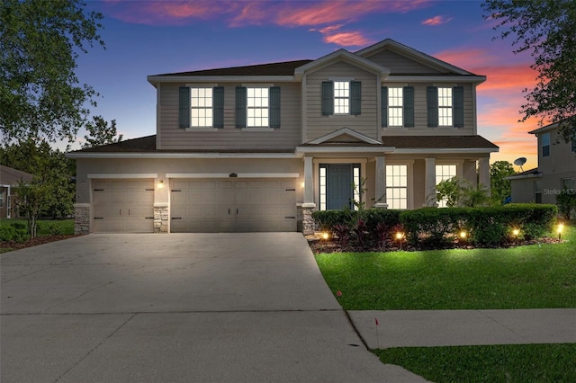 13619 Hunters Point St, Spring Hill, FL 34609 - view of front facade featuring an attached garage, concrete driveway, and stone siding
