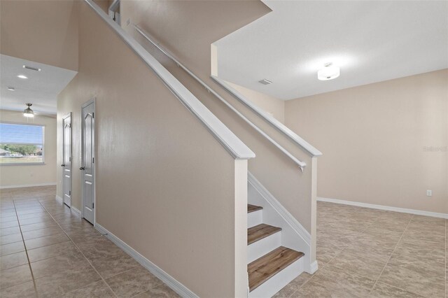 13619 Hunters Point St, Spring Hill, FL 34609 - staircase featuring visible vents, baseboards, a ceiling fan, and tile patterned flooring