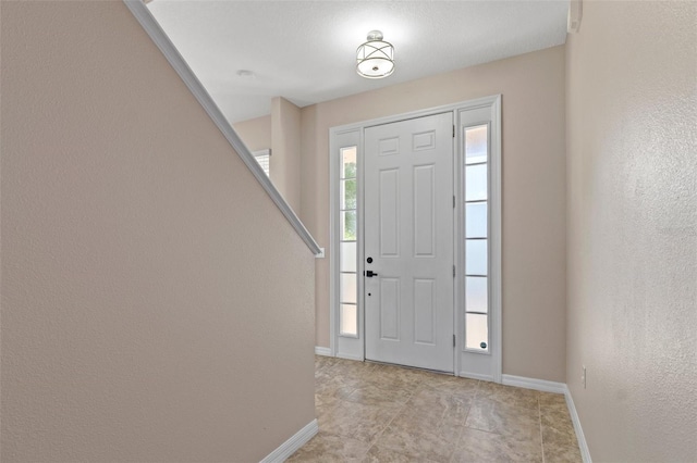 13619 Hunters Point St, Spring Hill, FL 34609 - foyer with baseboards and light tile patterned flooring