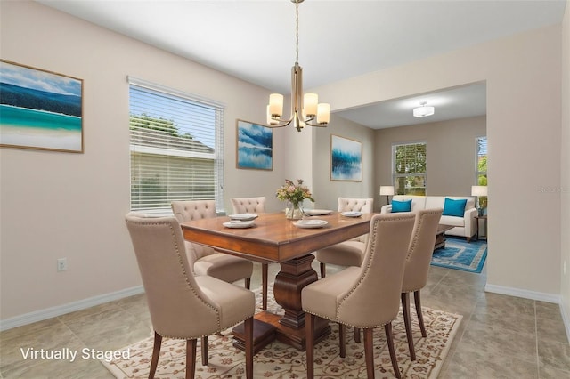 13619 Hunters Point St, Spring Hill, FL 34609 - dining space with a healthy amount of sunlight, a notable chandelier, and baseboards