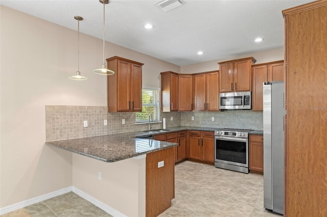 13619 Hunters Point St, Spring Hill, FL 34609 - kitchen with brown cabinets, visible vents, appliances with stainless steel finishes, and a peninsula