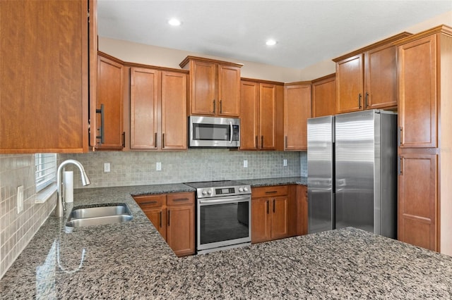 13619 Hunters Point St, Spring Hill, FL 34609 - kitchen featuring tasteful backsplash, brown cabinets, dark stone counters, appliances with stainless steel finishes, and a sink