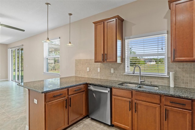 13619 Hunters Point St, Spring Hill, FL 34609 - kitchen with a peninsula, brown cabinetry, decorative backsplash, dishwasher, and a sink