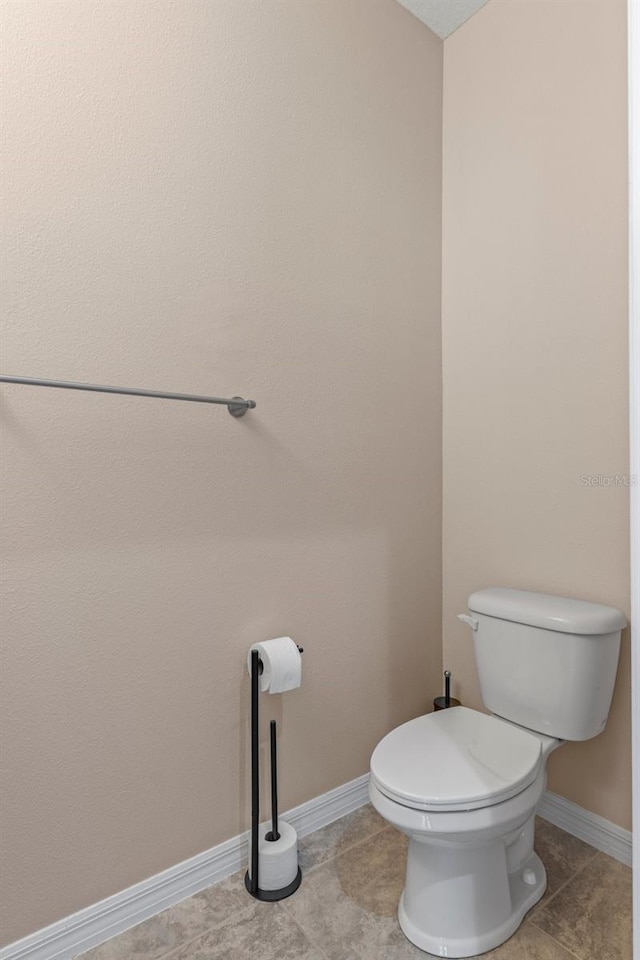 13619 Hunters Point St, Spring Hill, FL 34609 - bathroom featuring tile patterned floors, baseboards, and toilet