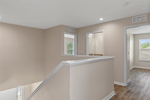 13619 Hunters Point St, Spring Hill, FL 34609 - hallway featuring light wood-style floors, an upstairs landing, visible vents, and baseboards