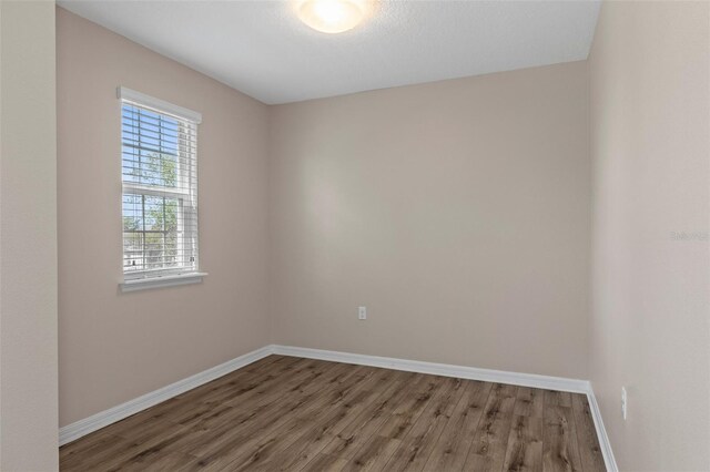 13619 Hunters Point St, Spring Hill, FL 34609 - unfurnished room featuring baseboards and wood finished floors