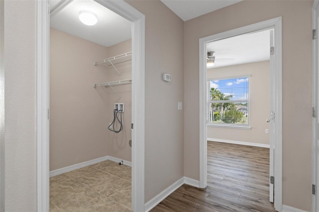 13619 Hunters Point St, Spring Hill, FL 34609 - laundry area with baseboards, wood finished floors, ceiling fan, and washer hookup