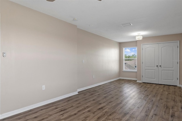 13619 Hunters Point St, Spring Hill, FL 34609 - unfurnished room with baseboards, ceiling fan, and wood finished floors