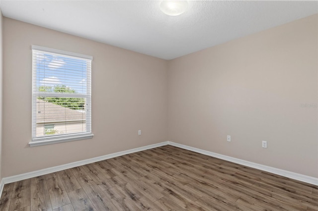13619 Hunters Point St, Spring Hill, FL 34609 - spare room with baseboards and wood finished floors