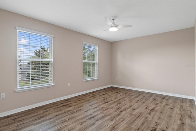 13619 Hunters Point St, Spring Hill, FL 34609 - empty room featuring baseboards, ceiling fan, and wood finished floors
