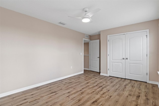 13619 Hunters Point St, Spring Hill, FL 34609 - unfurnished bedroom with light wood-type flooring, a closet, baseboards, and visible vents
