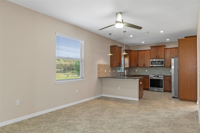13619 Hunters Point St, Spring Hill, FL 34609 - kitchen with a sink, ceiling fan, appliances with stainless steel finishes, brown cabinetry, and decorative backsplash