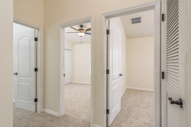 corridor featuring carpet and baseboards