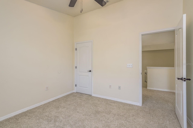 unfurnished bedroom featuring carpet flooring, baseboards, and a ceiling fan