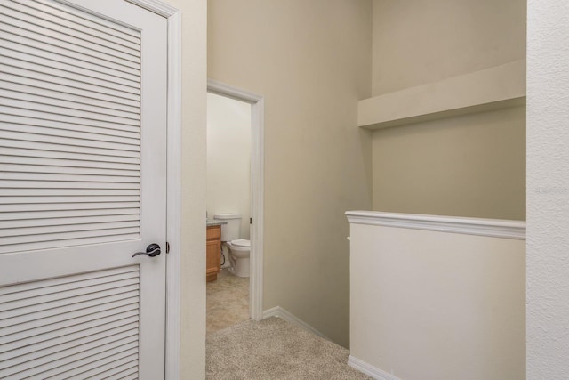 bathroom featuring toilet and baseboards