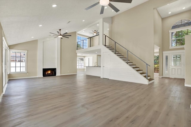 10423 Ashley Oaks Dr, Riverview, FL 33578 - unfurnished living room with recessed lighting, a large fireplace, stairway, ceiling fan, and high vaulted ceiling