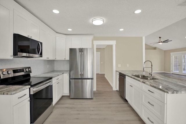 10423 Ashley Oaks Dr, Riverview, FL 33578 - kitchen with a sink, light wood-type flooring, white cabinetry, a peninsula, and appliances with stainless steel finishes