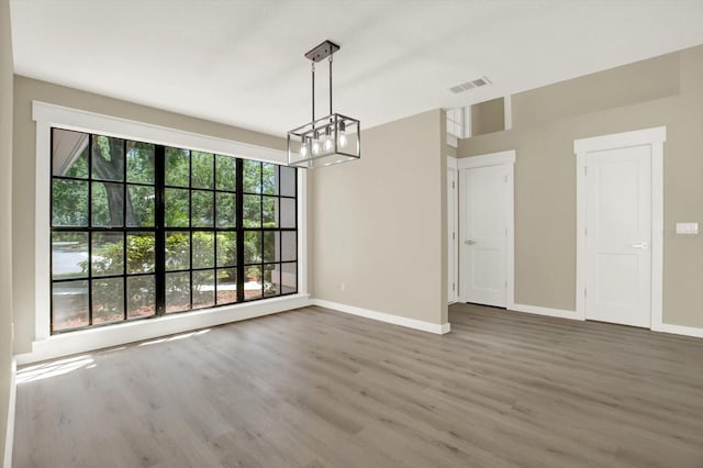 10423 Ashley Oaks Dr, Riverview, FL 33578 - unfurnished dining area featuring visible vents, baseboards, wood finished floors, and a chandelier