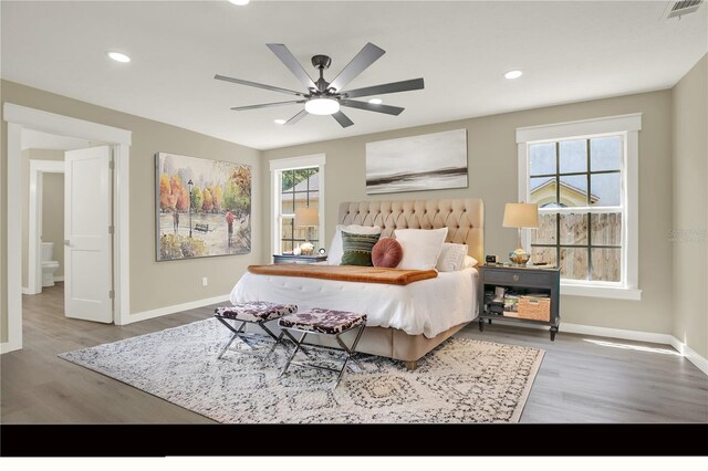 10423 Ashley Oaks Dr, Riverview, FL 33578 - bedroom featuring wood finished floors, visible vents, baseboards, and multiple windows