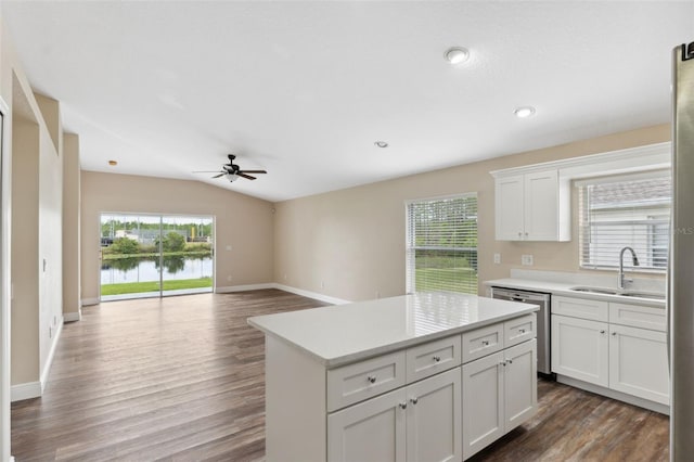 kitchen featuring stainless steel dishwasher, white cabinetry, a ceiling fan, light countertops, and a sink