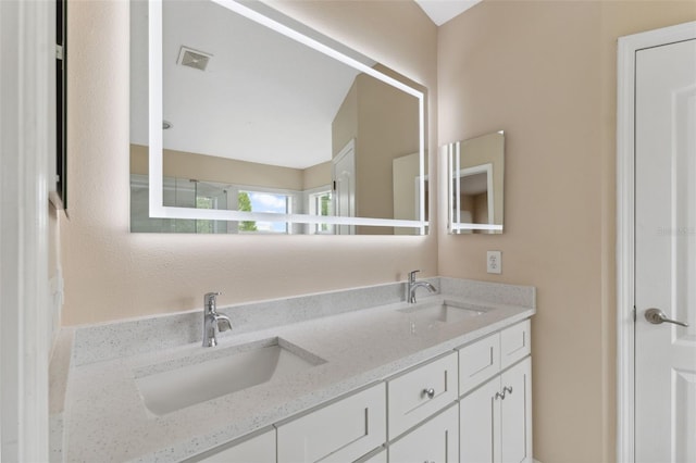 full bathroom with double vanity, visible vents, and a sink