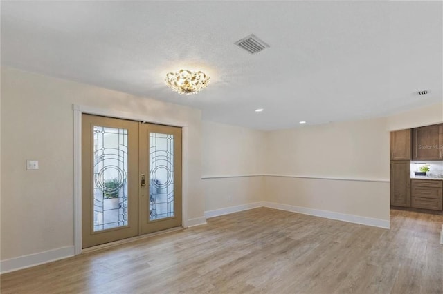 5033 Cabrilla Ct, New Port Richey, FL 34652 - entrance foyer with french doors, light wood finished floors, healthy amount of natural light, and recessed lighting