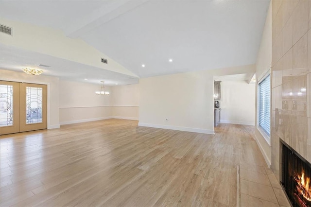 5033 Cabrilla Ct, New Port Richey, FL 34652 - unfurnished living room featuring a tiled fireplace, beamed ceiling, light wood-style flooring, a chandelier, and recessed lighting