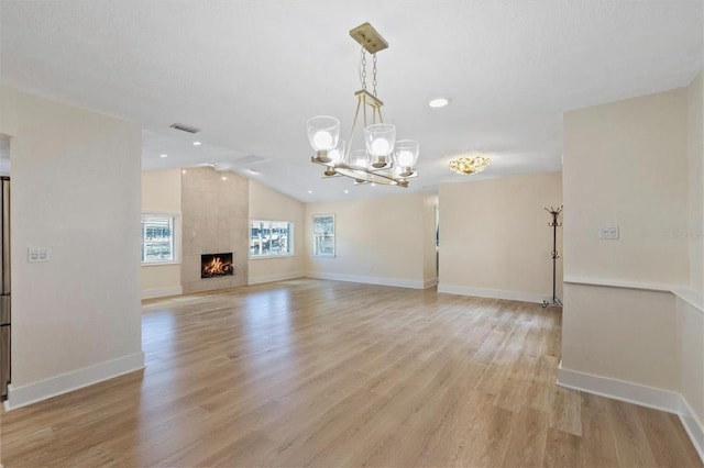 5033 Cabrilla Ct, New Port Richey, FL 34652 - unfurnished living room featuring a chandelier, vaulted ceiling, light wood-style floors, a large fireplace, and recessed lighting